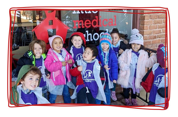 A group of kids and teens at a STEM summer camp with Little Medical School