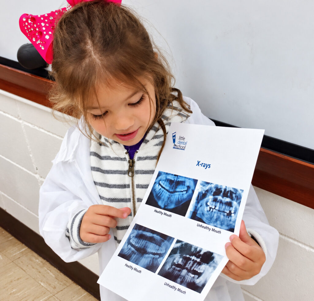 Student Holding Dental Chart