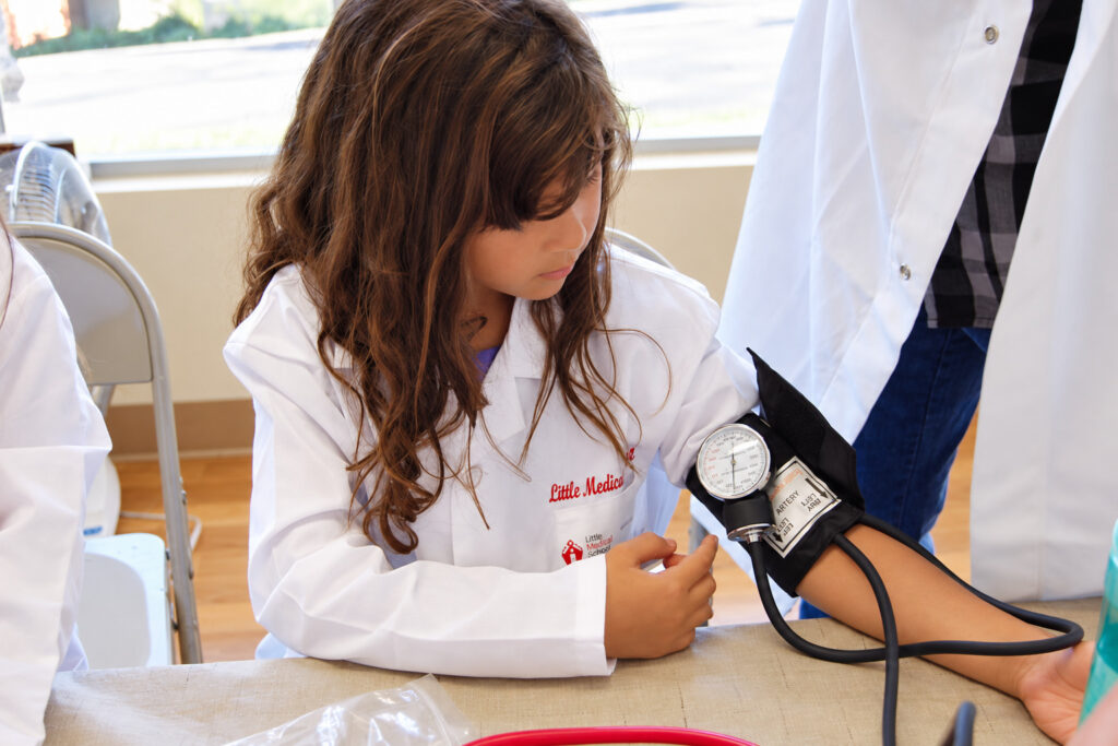 Student practicing blood pressure with a cuff