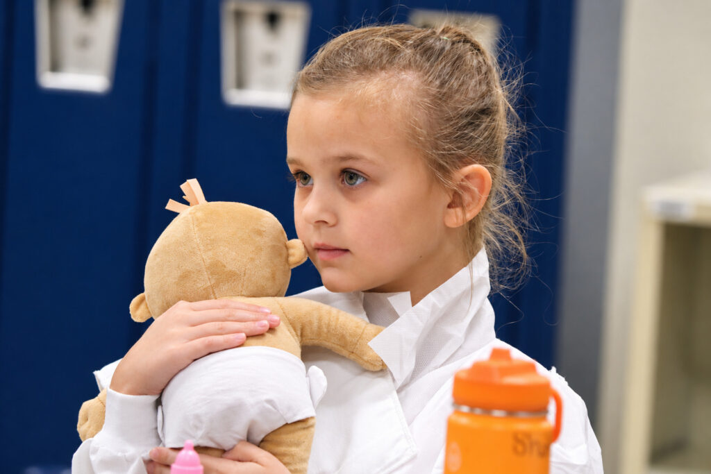 Young researcher with a teaching doll