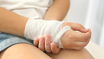 Close up view of small child's wrist in a bandage